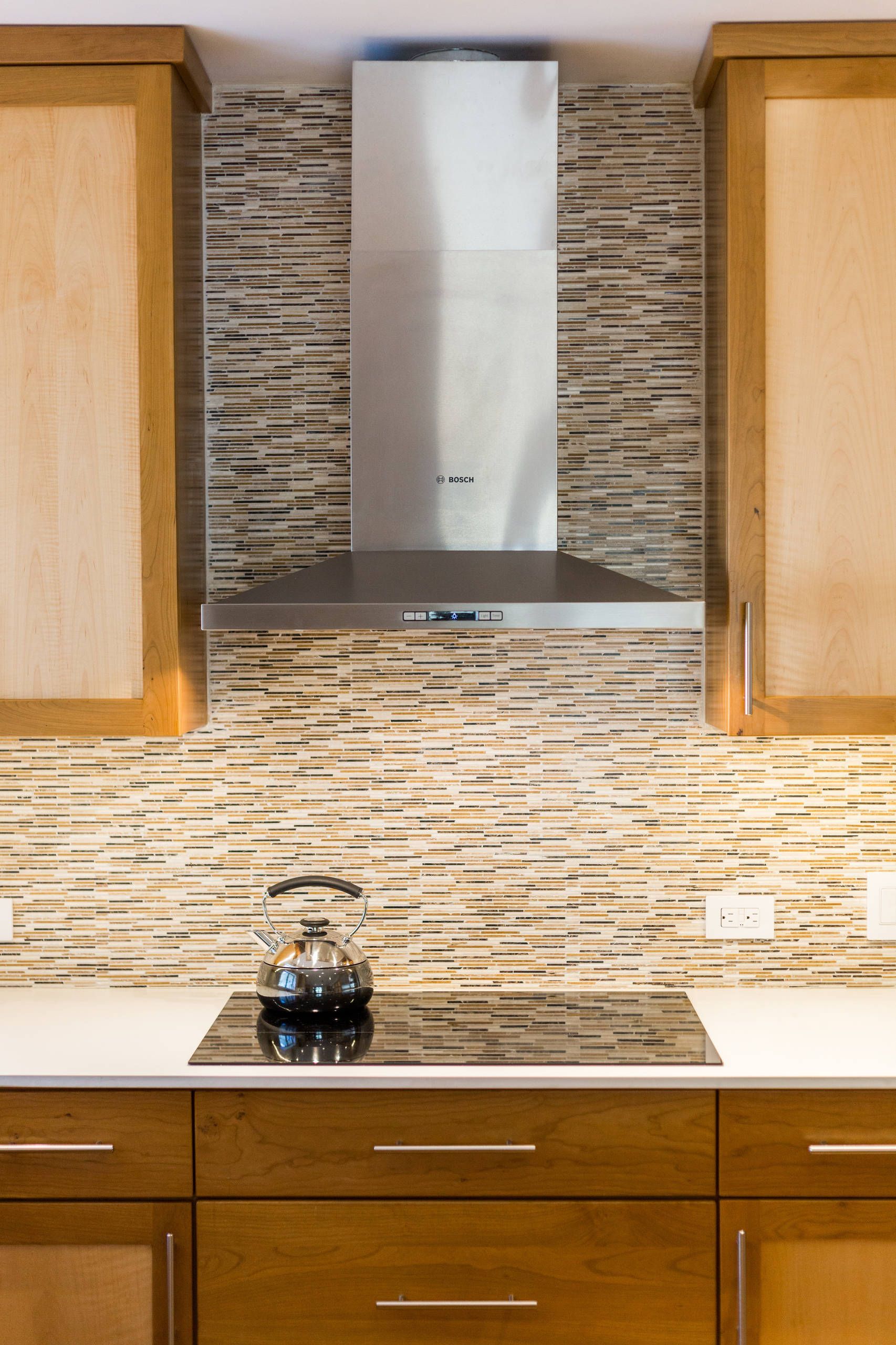 A kitchen with a stove top oven and a stainless steel hood. James McCoy Remodeling Services Serving 19072,19003,19118,19444,19095 and surrounding areas