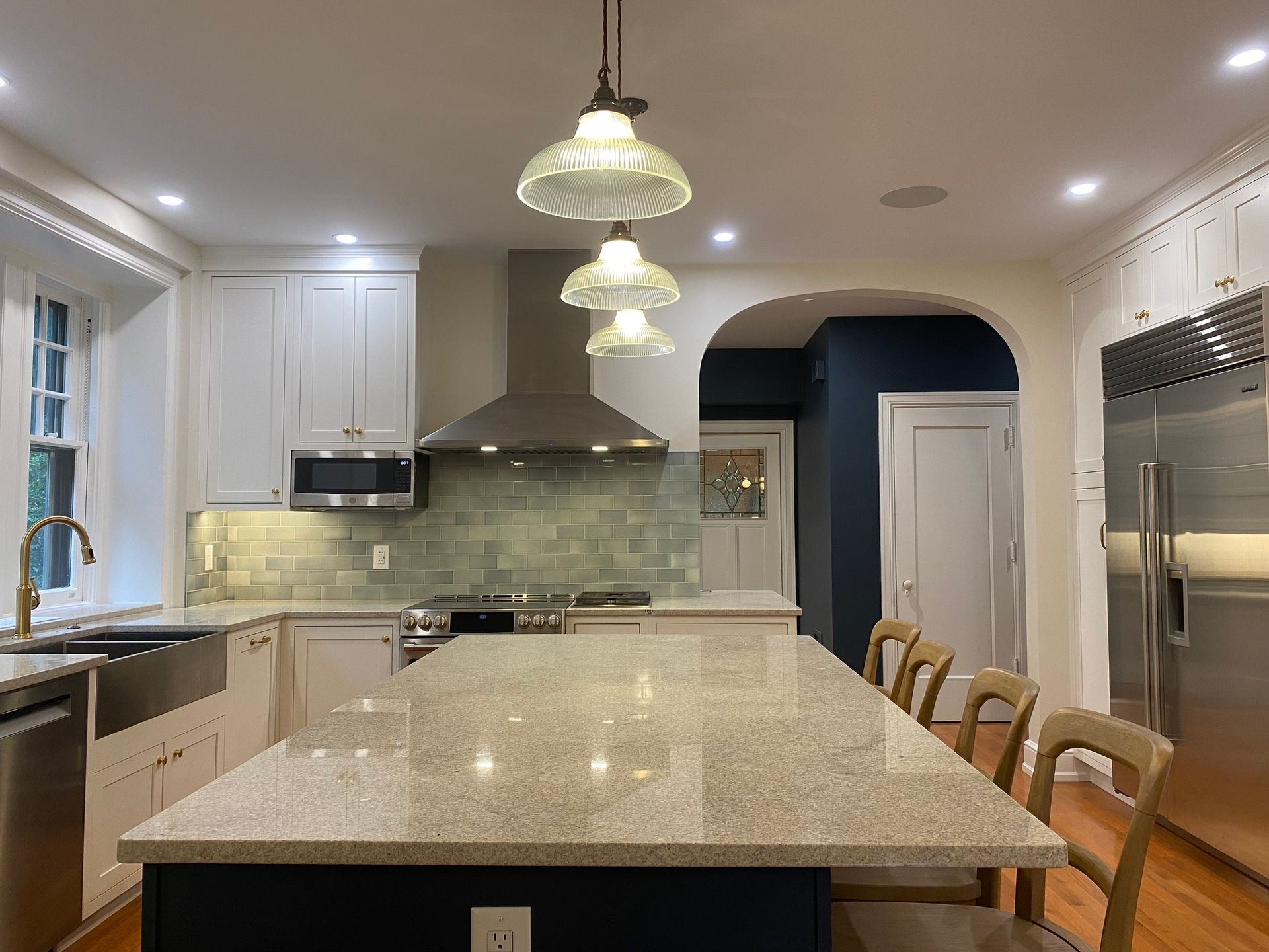 A kitchen with a large island and stainless steel appliances.