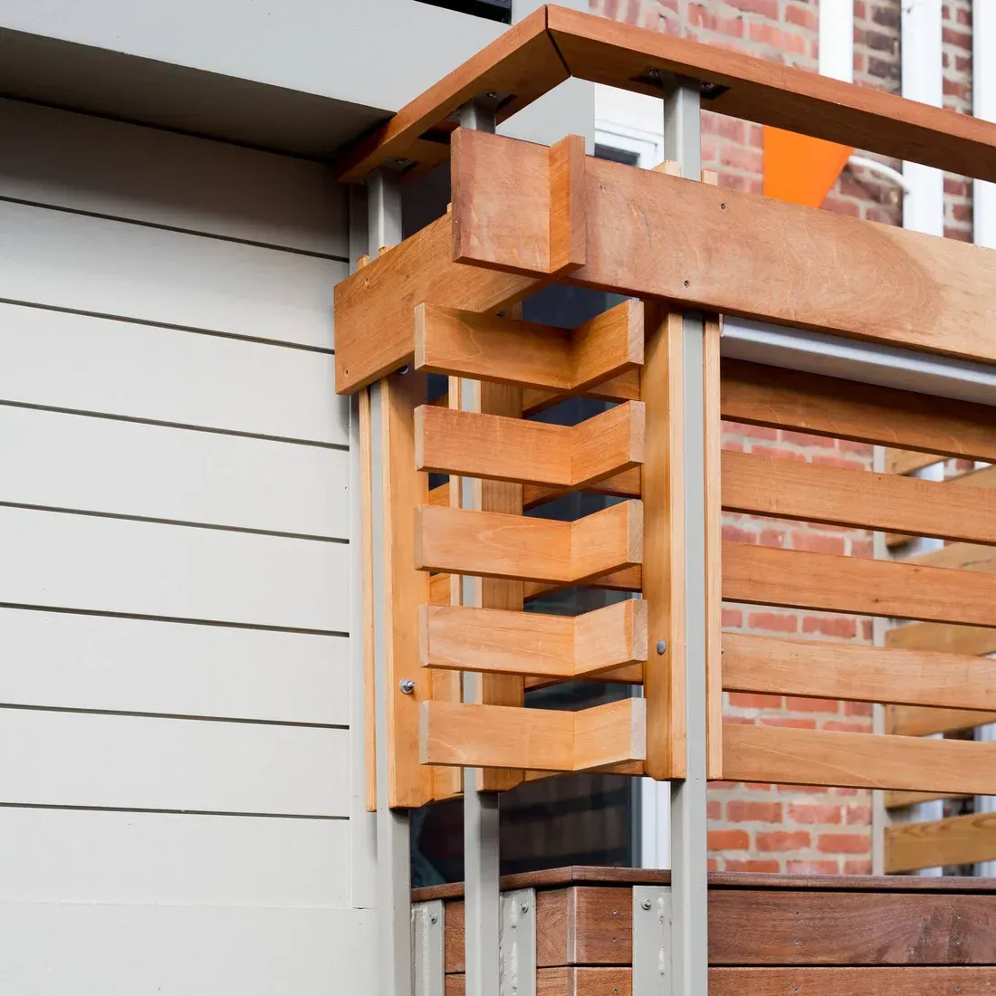 A balcony with a wooden railing on the side of a building. James McCoy Remodeling Services Serving 19072,19003,19118,19444,19095 and surrounding areas