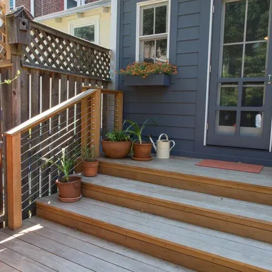 Stairs leading up to a house with potted plants and a watering can. James McCoy Remodeling Services Serving 19072,19003,19118,19444,19095 and surrounding areas