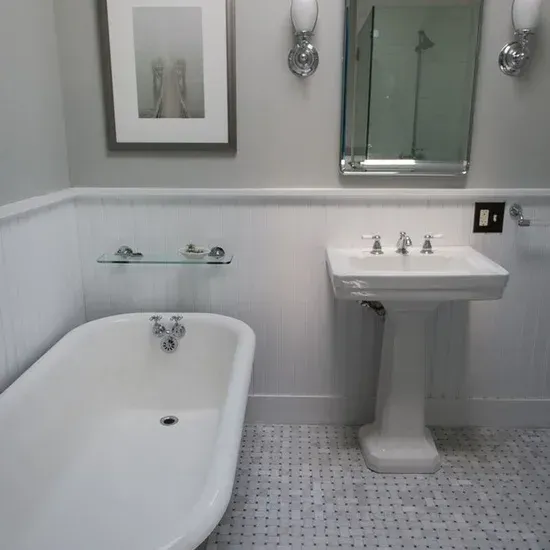 A bathroom with a bathtub a sink and a mirror