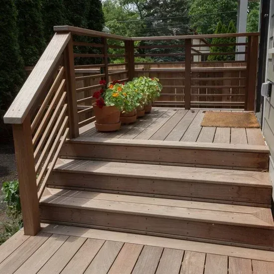 A wooden deck with stairs and potted plants on it.James McCoy Remodeling Services Serving 19072,19003,19118,19444,19095 and surrounding areas