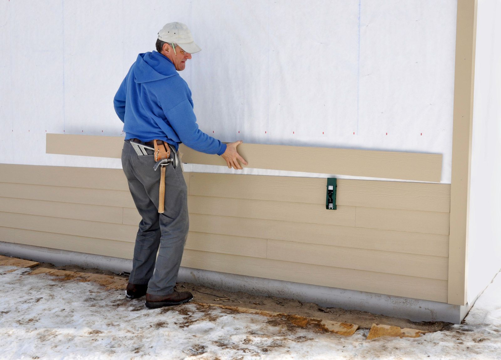 Carpenter Installing Siding — Madison, WI — TOTL Construction, LLC Carpenter Installing Siding — Madison, WI — TOTL Construction, LLC
