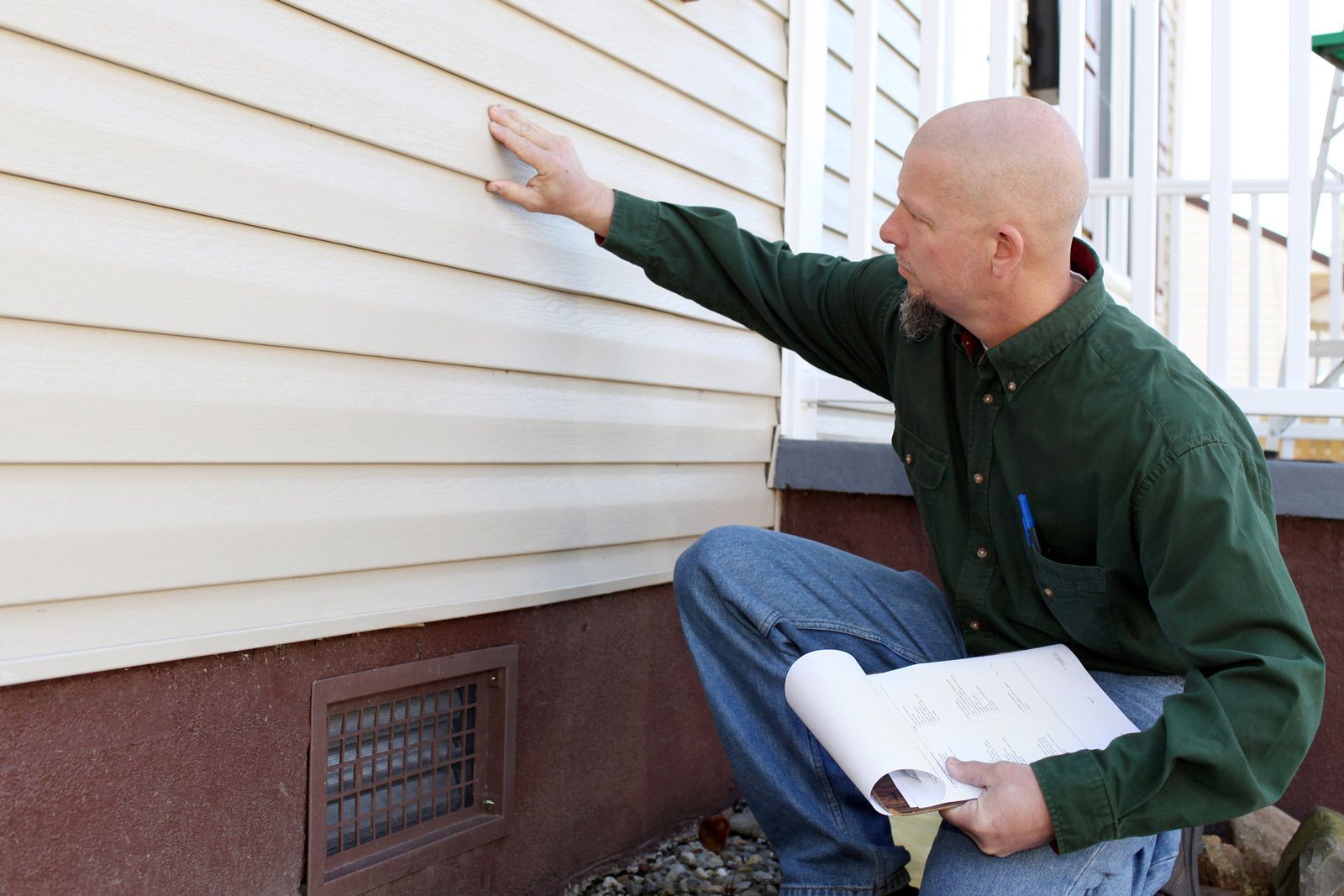 Checking Out Aluminum Siding — Madison, WI — TOTL Construction, LLC Checking Out Aluminum Siding — Madison, WI — TOTL Construction, LLC