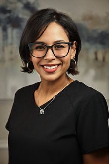 Portrait of Yakra Matias, doctor's assistant for Dr. Donald Marks against a blurred neutral background.
