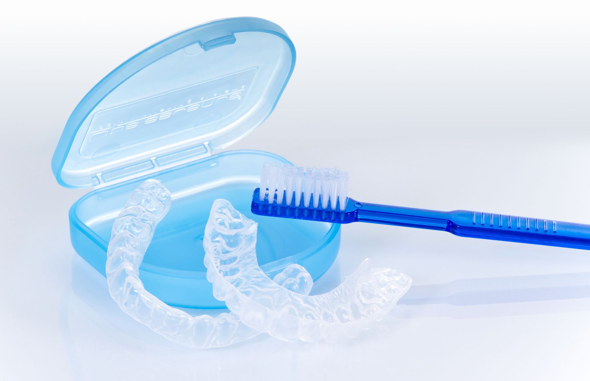 Transparent blue dental floss dispenser with a toothbrush