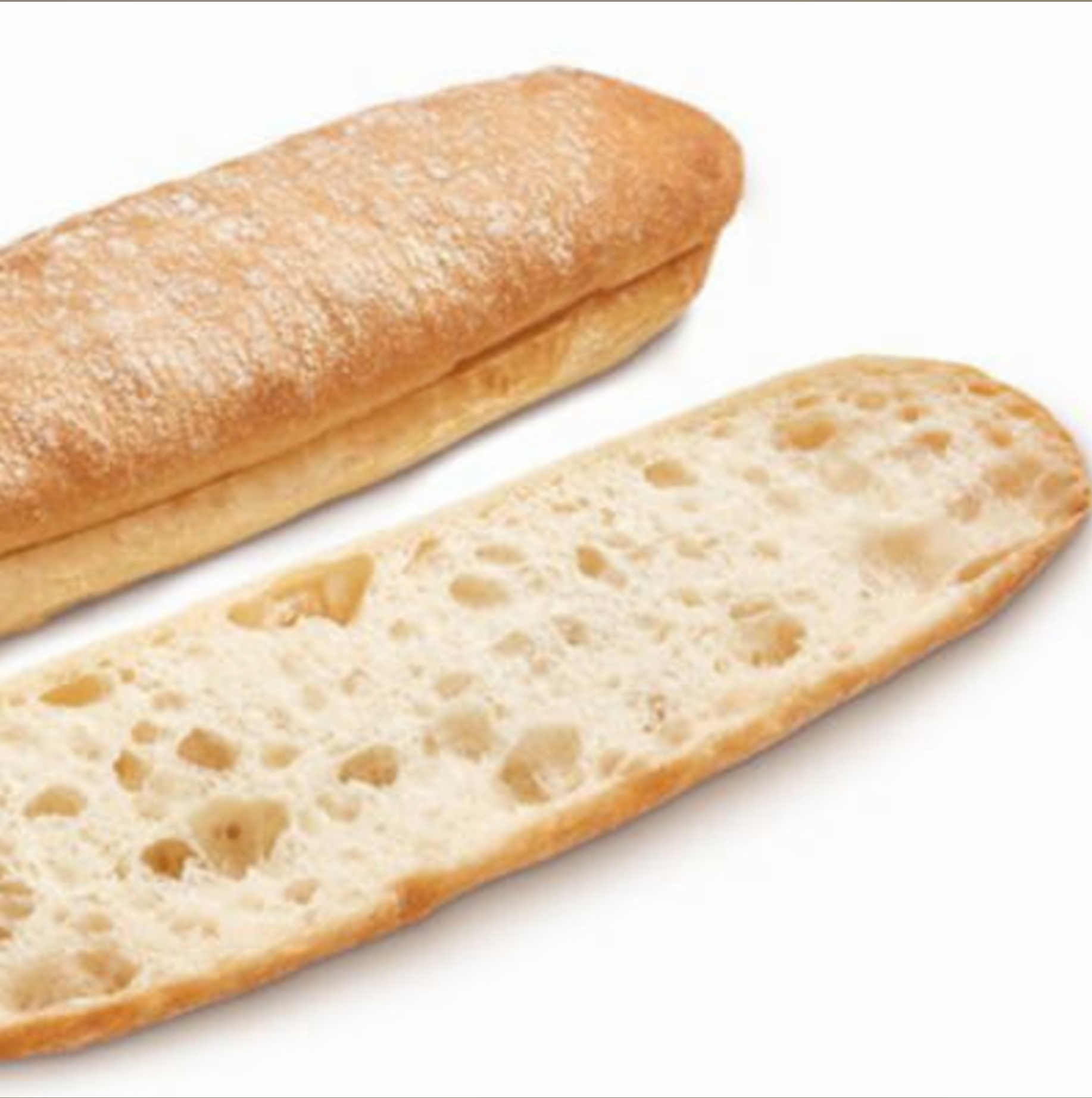 Two slices of crusty baguette, one whole and one cut open, on a white background