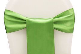 Green satin bow tied around a white chair back