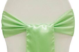 Light green satin bow tied around a white chair back