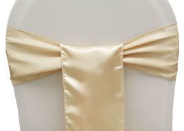 Cream satin chair sash with a central bow on a white chair back
