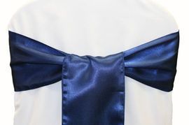 Blue satin ribbon tied in a bow around a white chair back