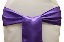 Purple satin chair sash tied in a bow on a white chair back