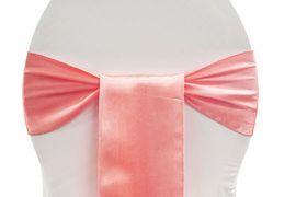 Pink satin bow tied around the back of a white chair