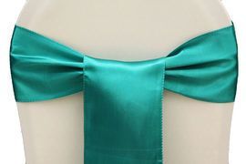 Turquoise satin bow tied around a white mannequin waist