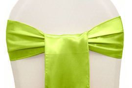 Lime green satin bow tied around a white mannequin waist