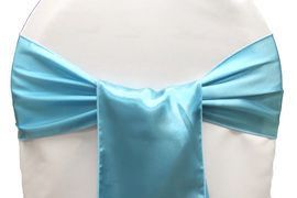Light blue satin bow tied around a white chair back
