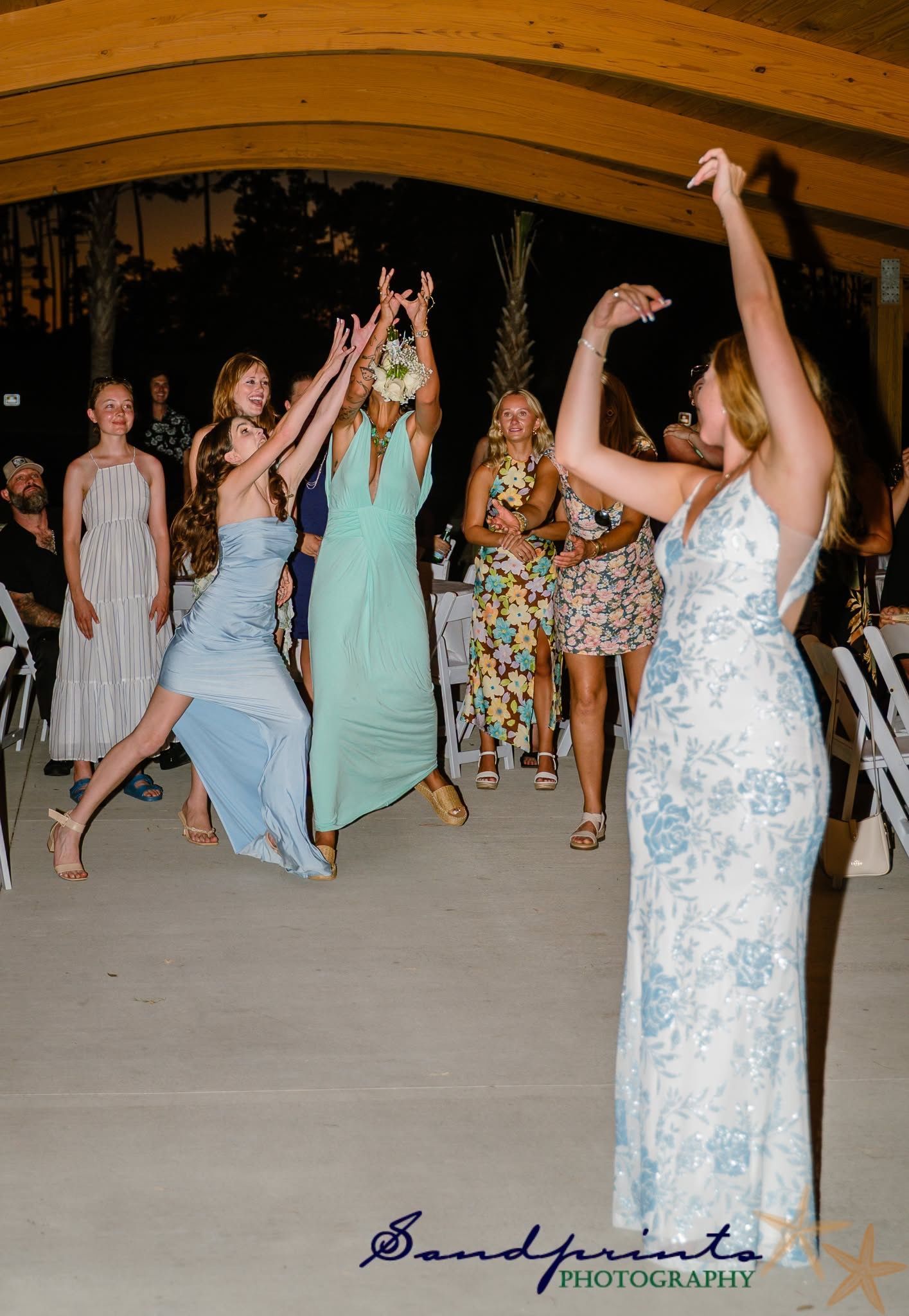 People dancing at a formal event, with one woman in a light blue dress in the foreground