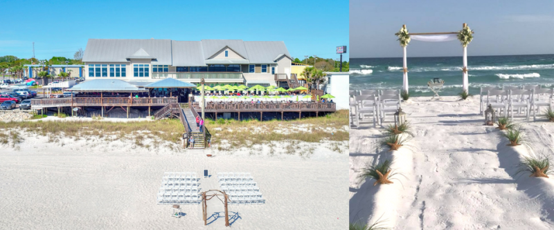 Beachfront resort with white sand, ocean waves, and a wooden walkway leading to a pier and seaside buildings