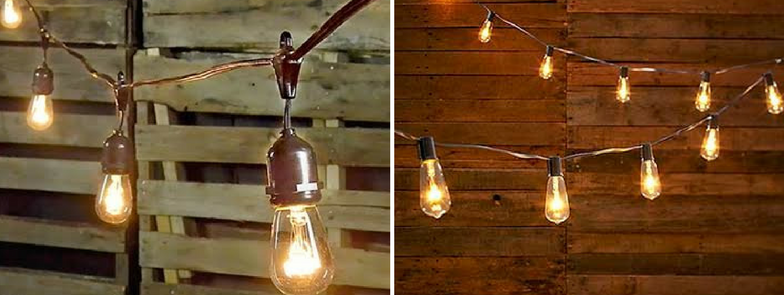 Warm string lights hanging over a rustic wooden fence at dusk