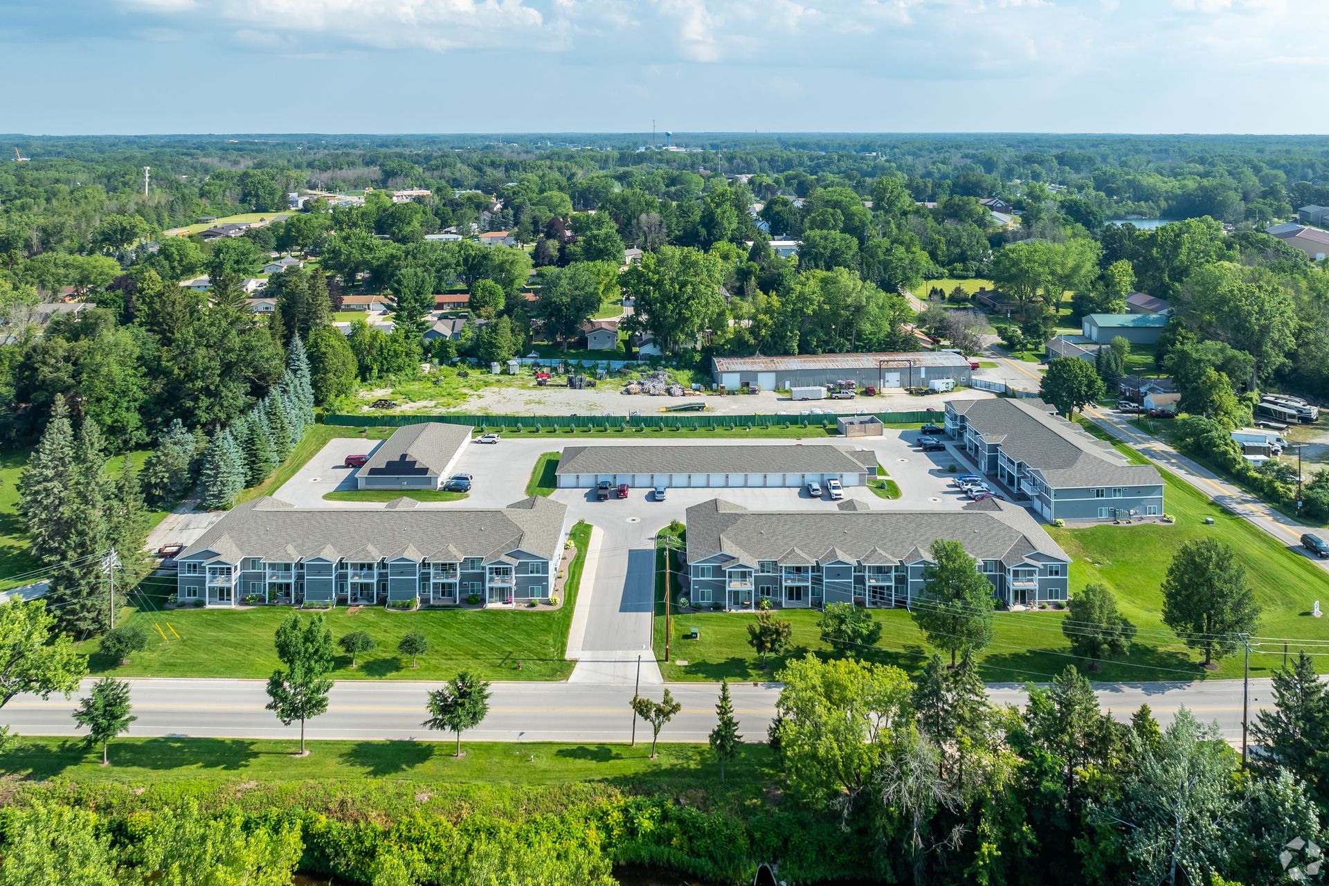 Aerial view of a large school campus with buildings, parking lots, and trees in a suburban area