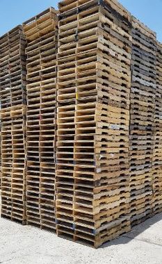 Stack of wooden pallets in a warehouse yard