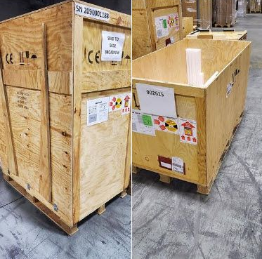 Wooden shipping crates in a warehouse, labeled and sealed with straps.