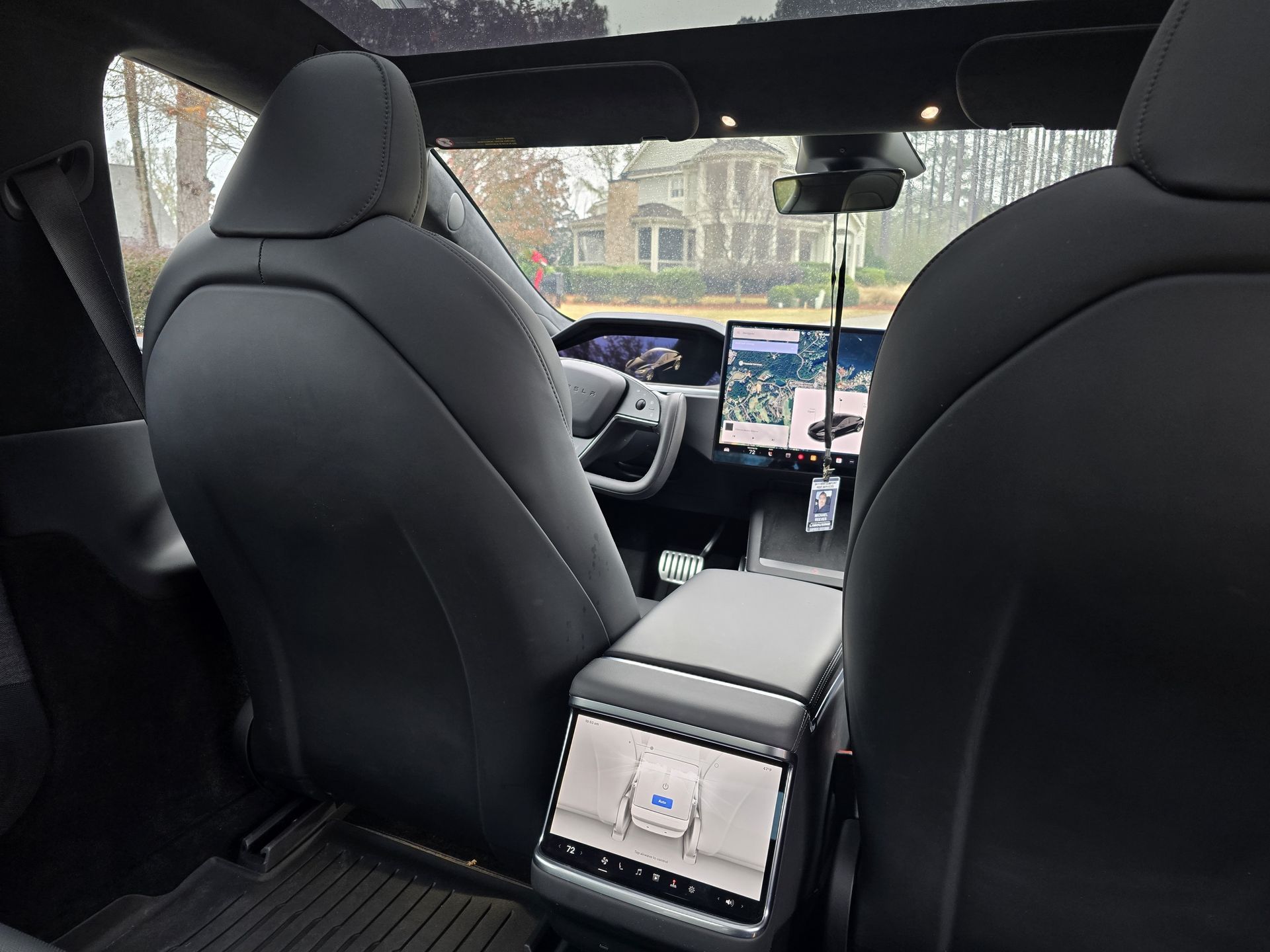 A man in a suit is sitting in a black car