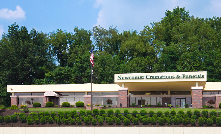 a large brick building with a parking lot in front of it