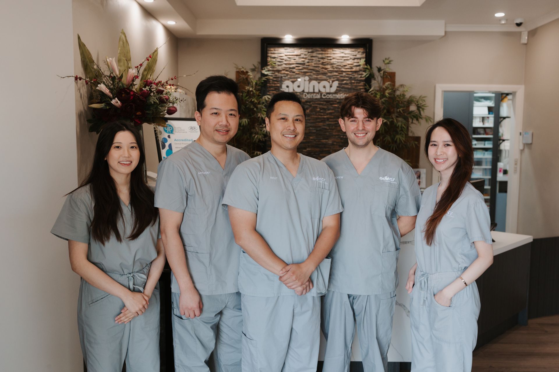 dental clinicians standing aline and smiling