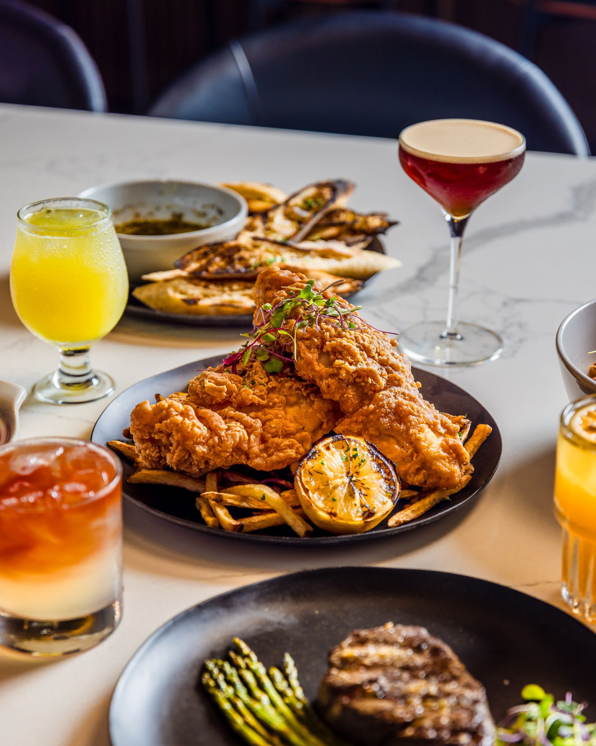 A table with plates of food and drinks on it