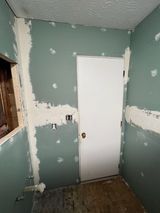 a room with green walls and a white door .