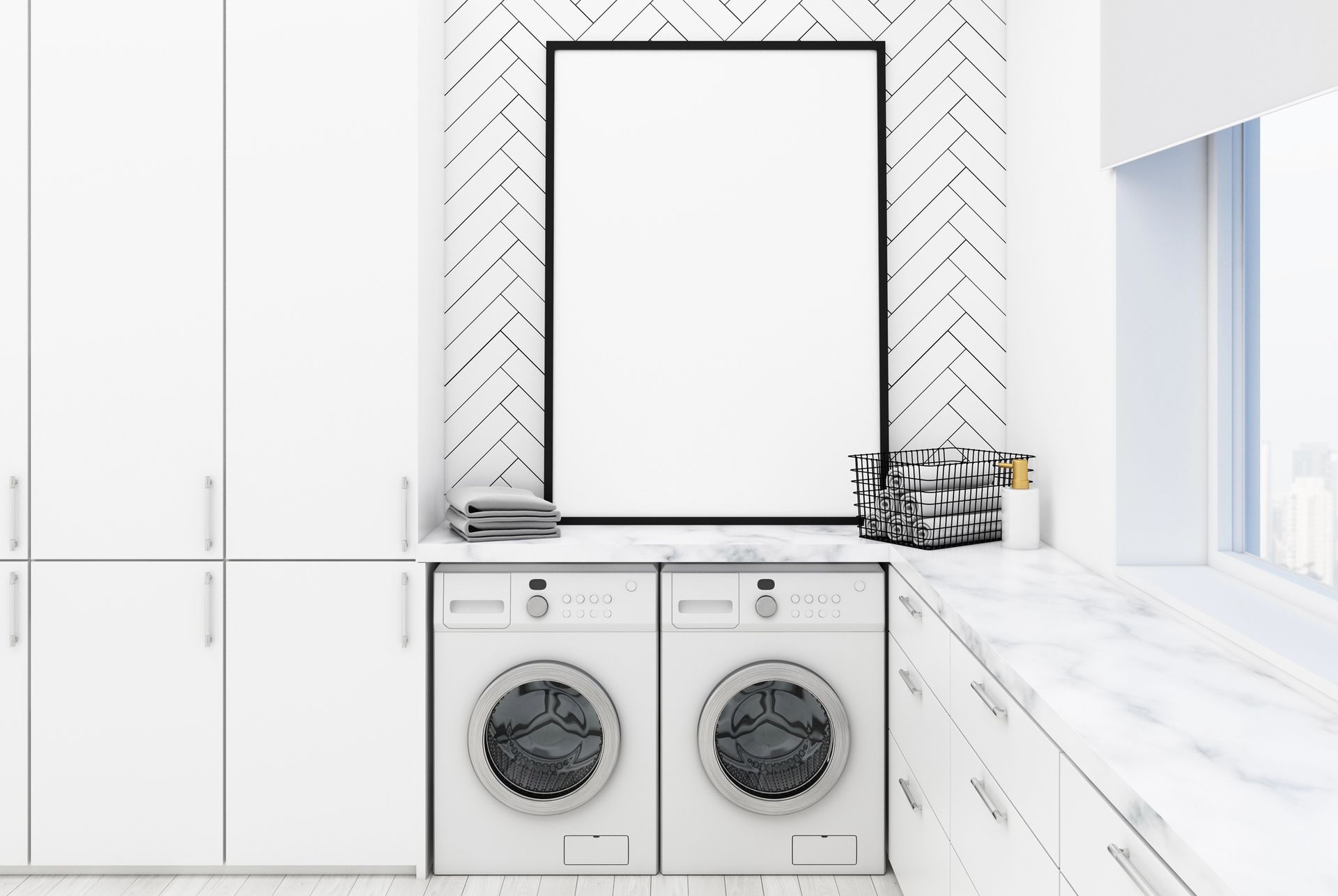 Bright laundry room with front-loading washer and dryer under a large mirror, white cabinets, and marble counters