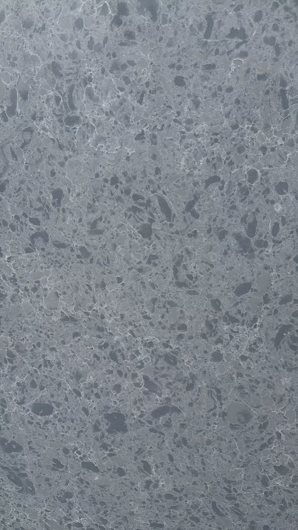 Gray speckled stone or concrete surface with a rough, mottled texture