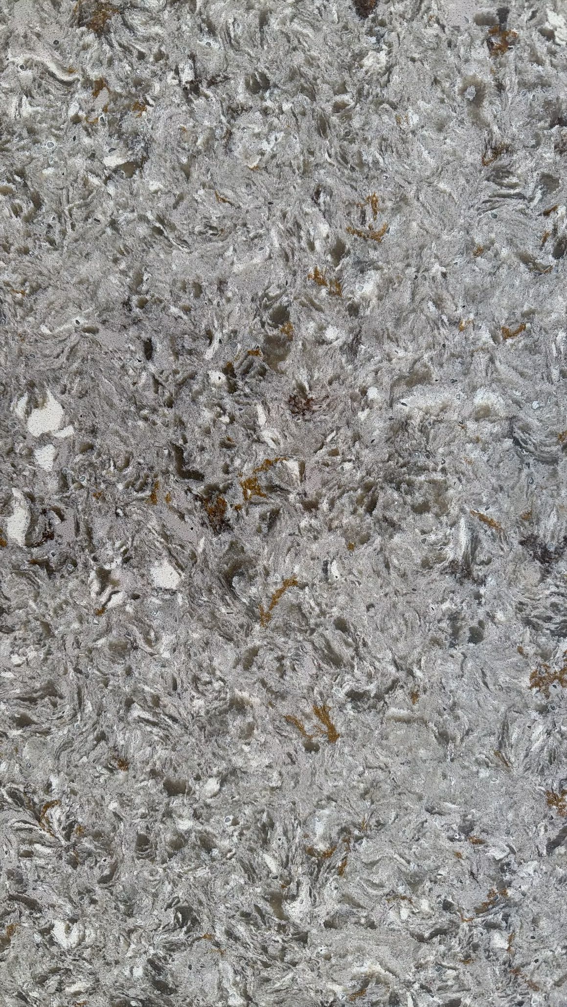 Close-up of a gray, speckled stone or concrete surface with a rough texture.
