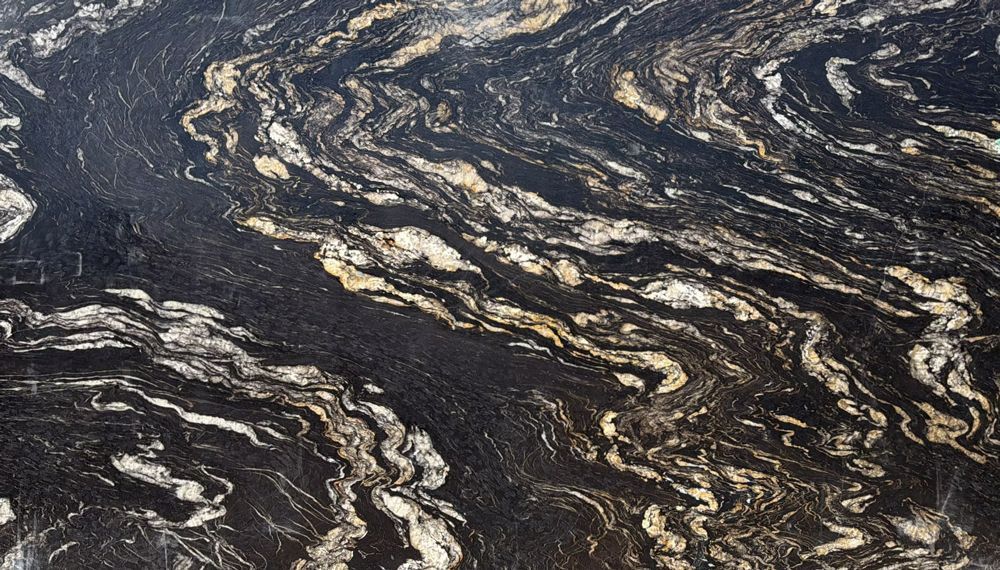 Dark marbled stone surface with swirling black, gray, and white veins