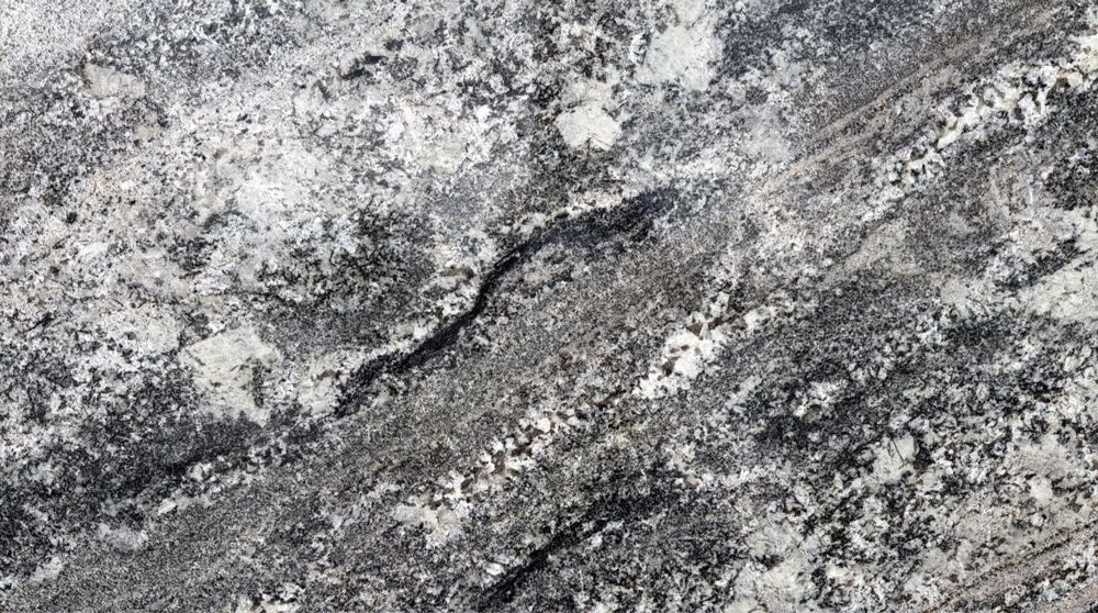 Gray and black speckled stone surface with diagonal veining