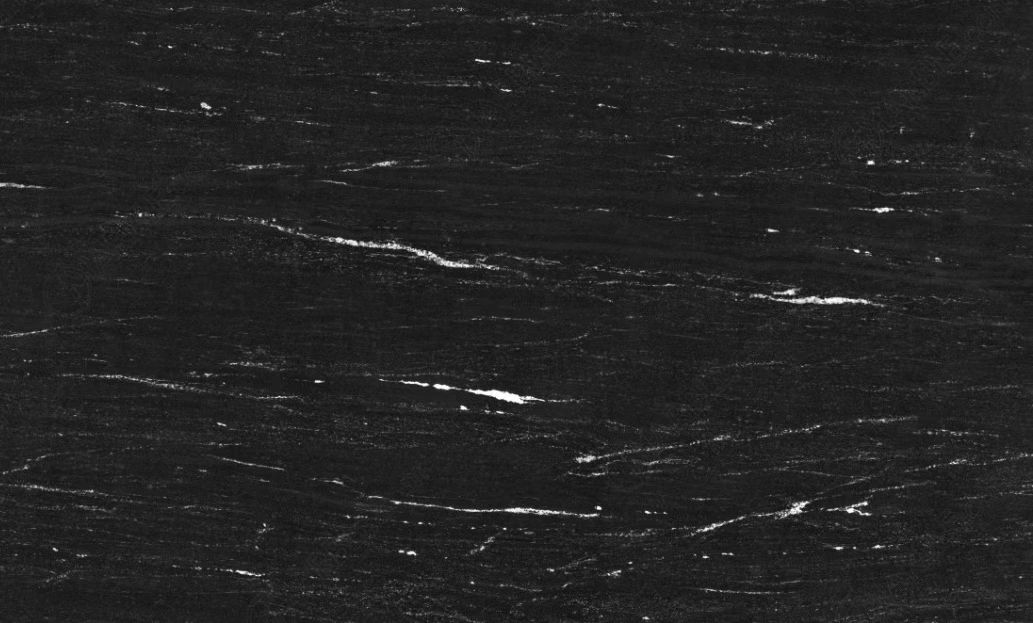 Dark textured surface with thin white scratches or streaks across it