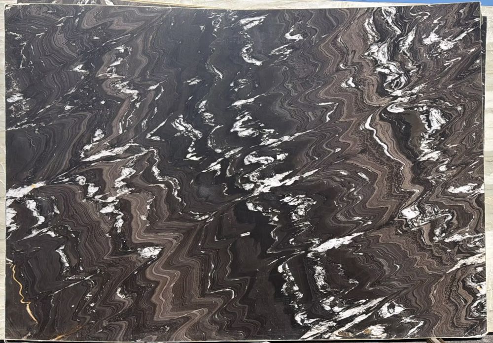 Dark brown and gray marble slab with white veining and wavy patterns