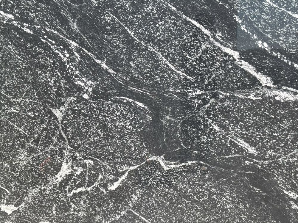 Dark gray and white marble or stone surface with veined texture