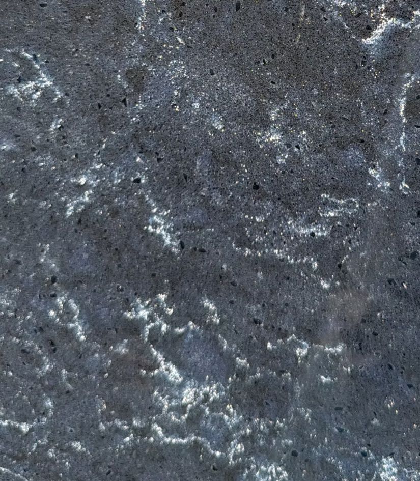 Close-up of gray speckled stone texture with white veining