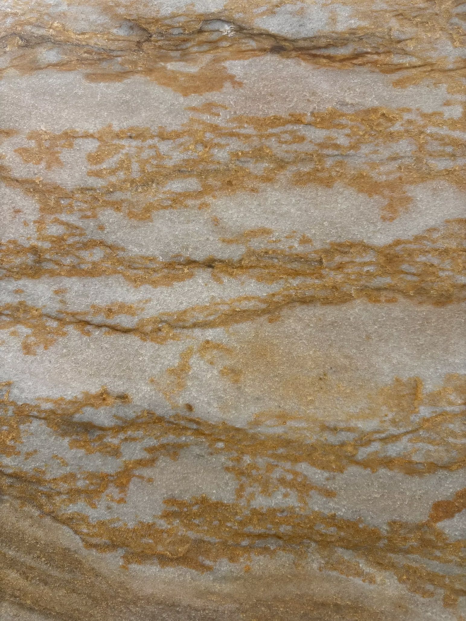 Beige and gold marbled stone pattern with wavy horizontal veins