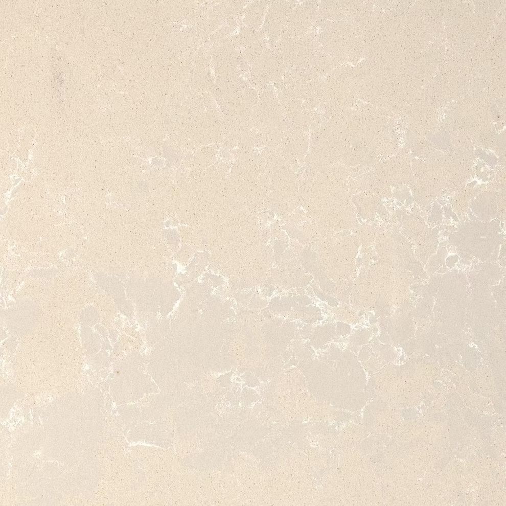 Close-up of a light beige marbled stone surface with faint white veining