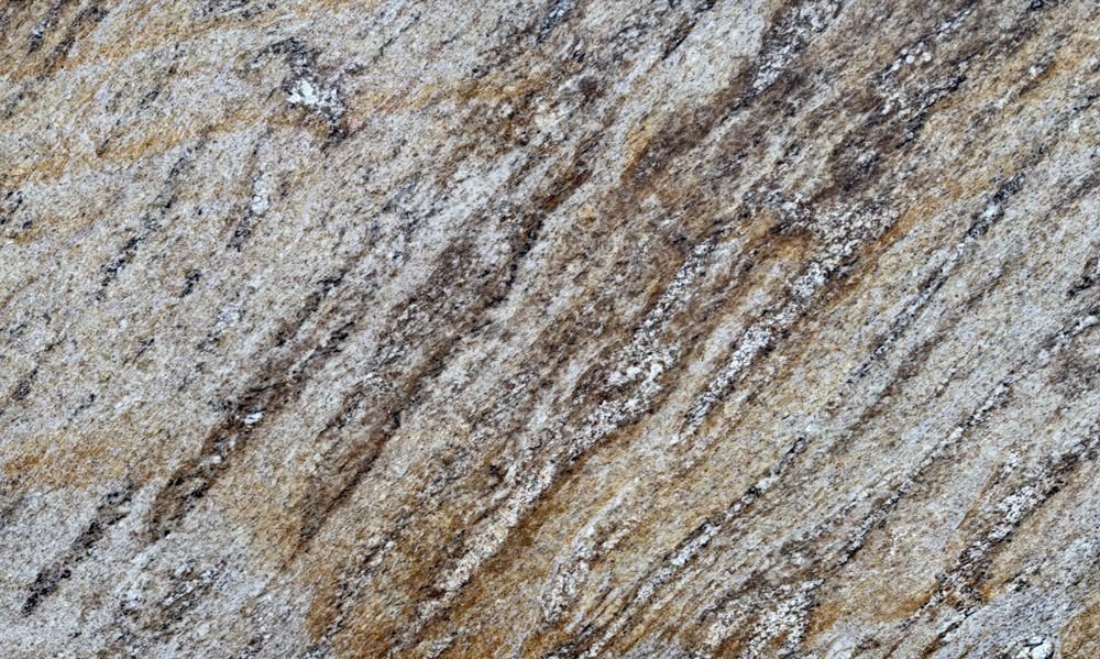 Gray and tan textured stone surface with diagonal dark veins