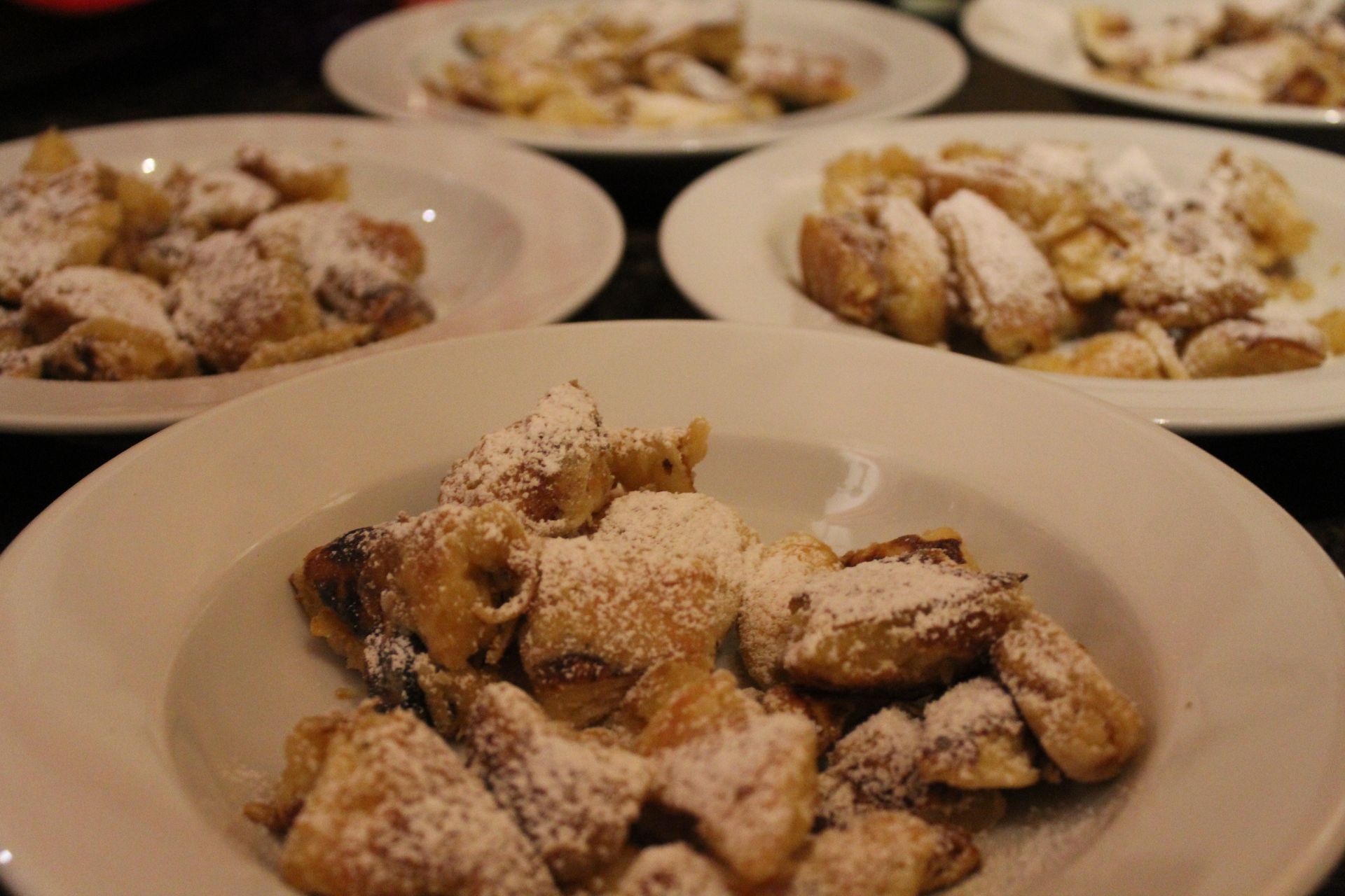 Bowls of Austrian Kaiserschmarrn dusted with powdered sugar.