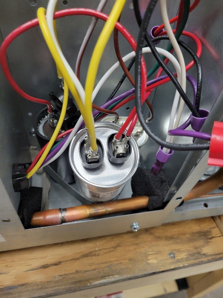 A bunch of wires are connected to a capacitor in a box.