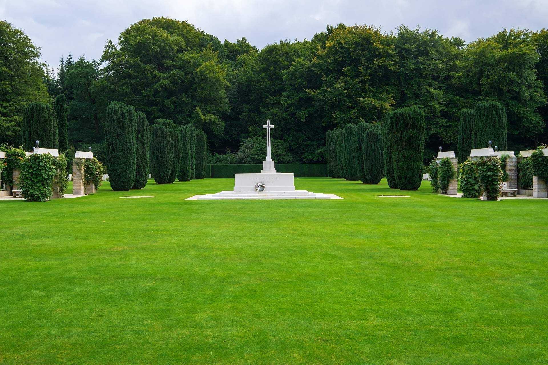 A cemetery with a cross in the middle of it