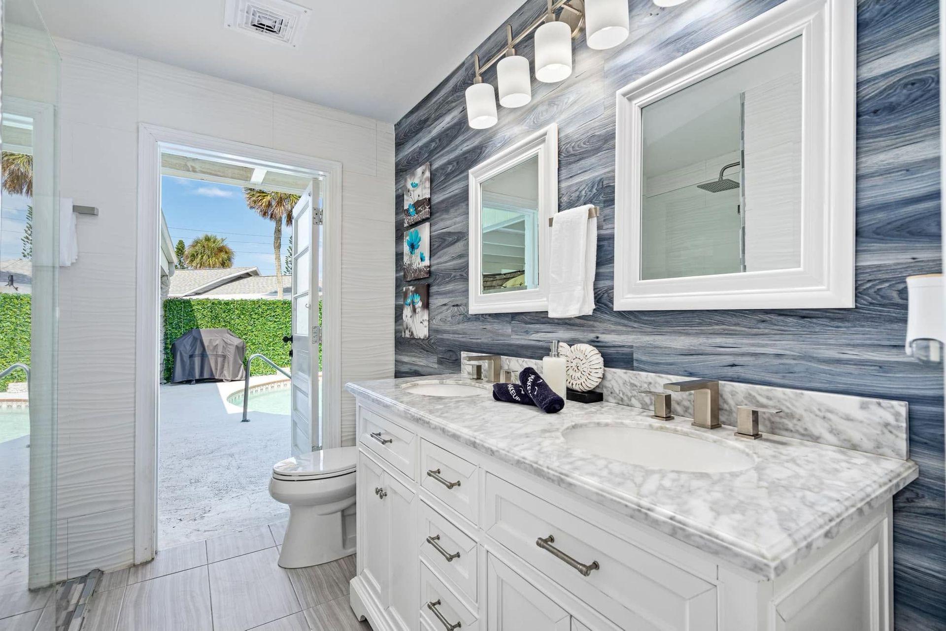 Small beige bathroom with sink vanity, toilet, mirror, and bathtub/shower combination