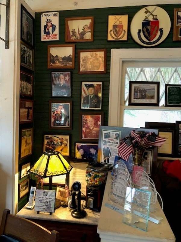 Cozy room with framed art wall, stained-glass lamp, and decorated wooden tabletop display