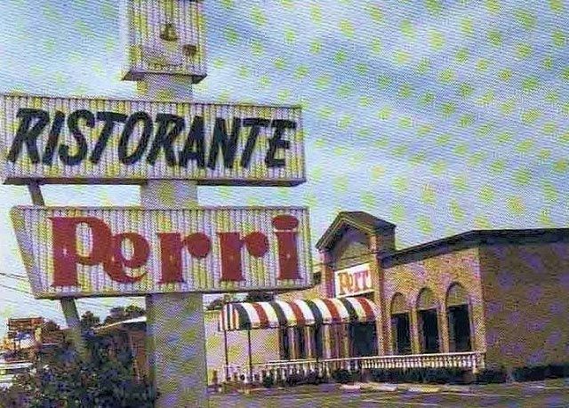 Ristorante Perri sign outside a restaurant with striped awning and arched windows