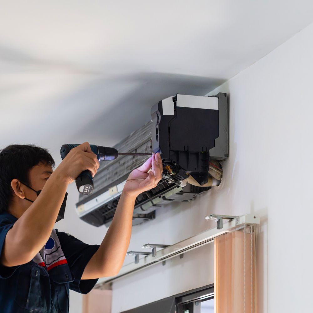 HVAC tech fixing air conditioner